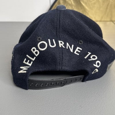 Black baseball cap featuring "Melbourne 1996 Australian Grand Prix" bold spellout, by Goodsports International.