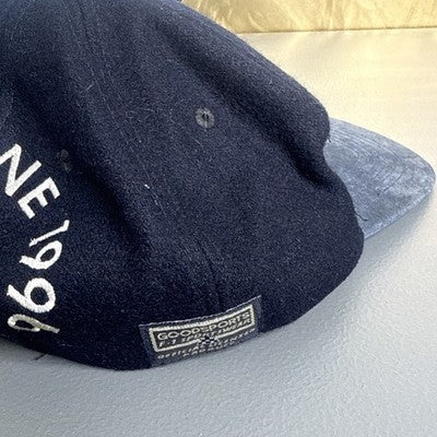 Black baseball cap featuring "Melbourne 1996 Australian Grand Prix" bold spellout, by Goodsports International.
