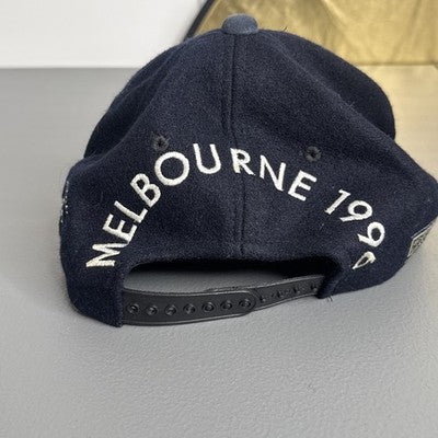Black baseball cap featuring "Melbourne 1996 Australian Grand Prix" bold spellout, by Goodsports International.
