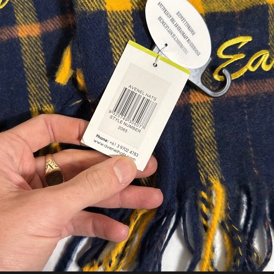 New West Coast Eagles AFL scarf by Avenel, featuring a retro navy, yellow, and brown tartan pattern with fringed ends.