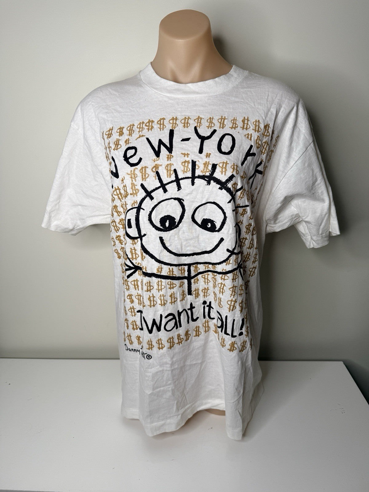 White vintage New York "I Want It All!" graphic T-shirt by Danny First, size XL, featuring a cartoon design and gold dollar signs.