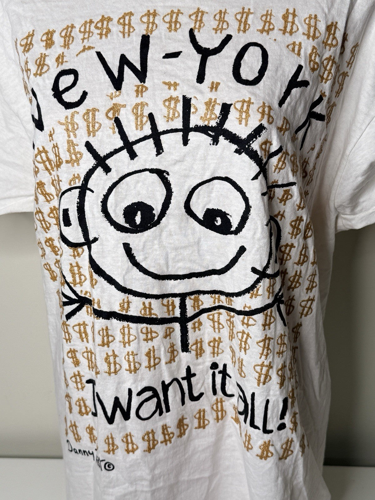 White vintage New York "I Want It All!" graphic T-shirt by Danny First, size XL, featuring a cartoon design and gold dollar signs.