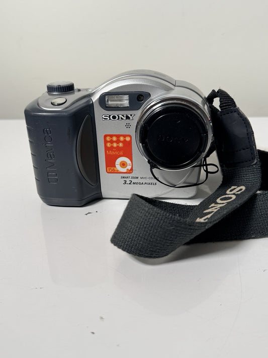 Vintage Sony Mavica MVC-CD350 digital camera in grey and silver, 3.2MP, includes strap and lens cap.
