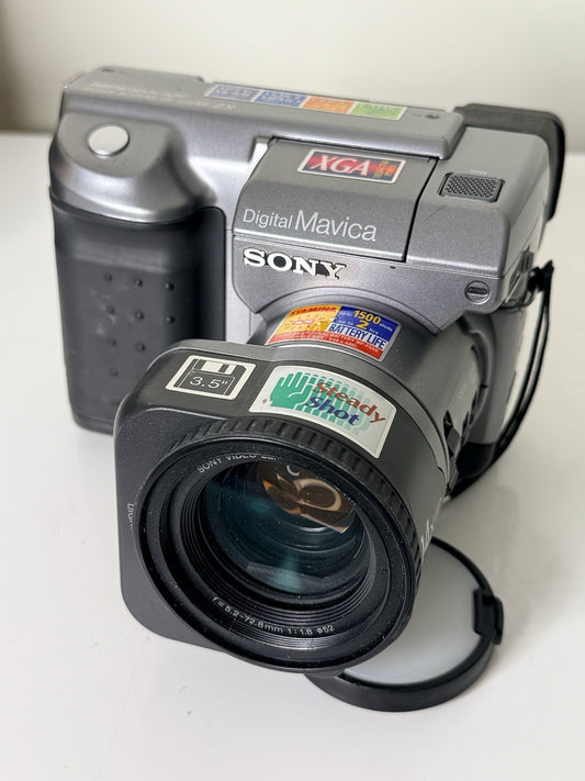 Vintage Sony Digital Mavica MVC-FD91 camera in black and grey, featuring 3.5-inch floppy disk storage.