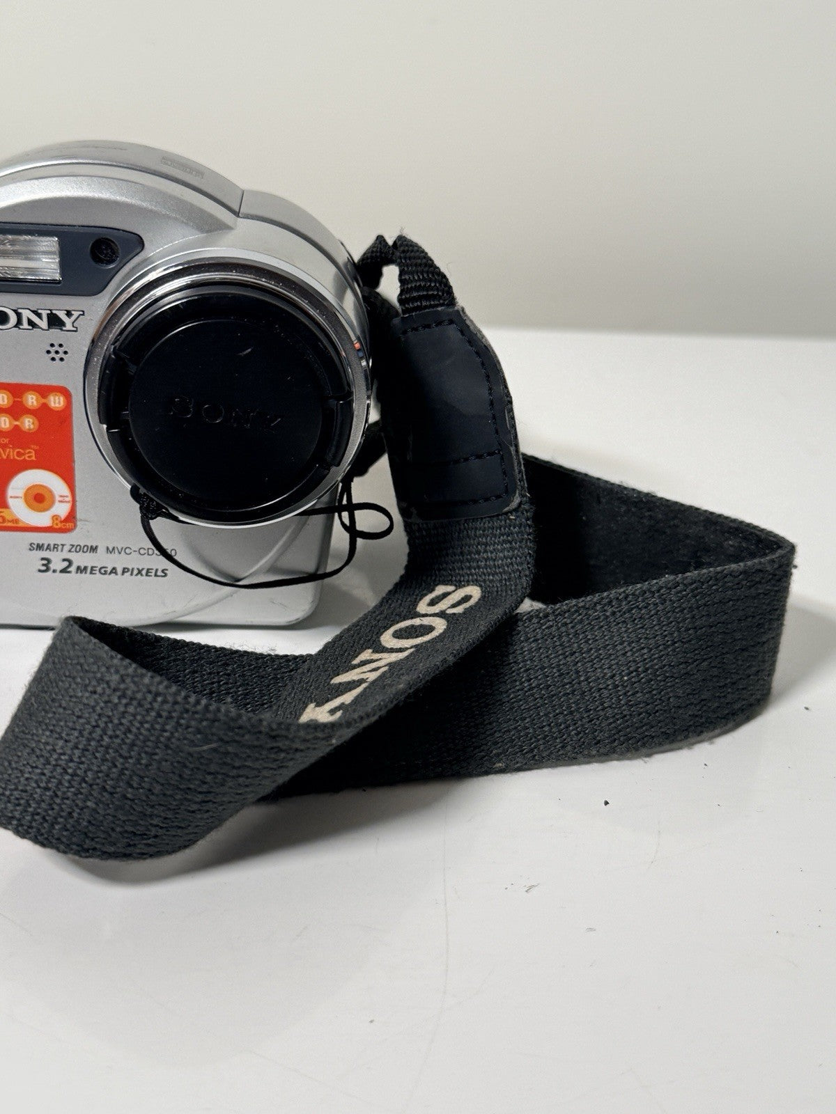 Vintage Sony Mavica MVC-CD350 digital camera in grey and silver, 3.2MP, includes strap and lens cap.