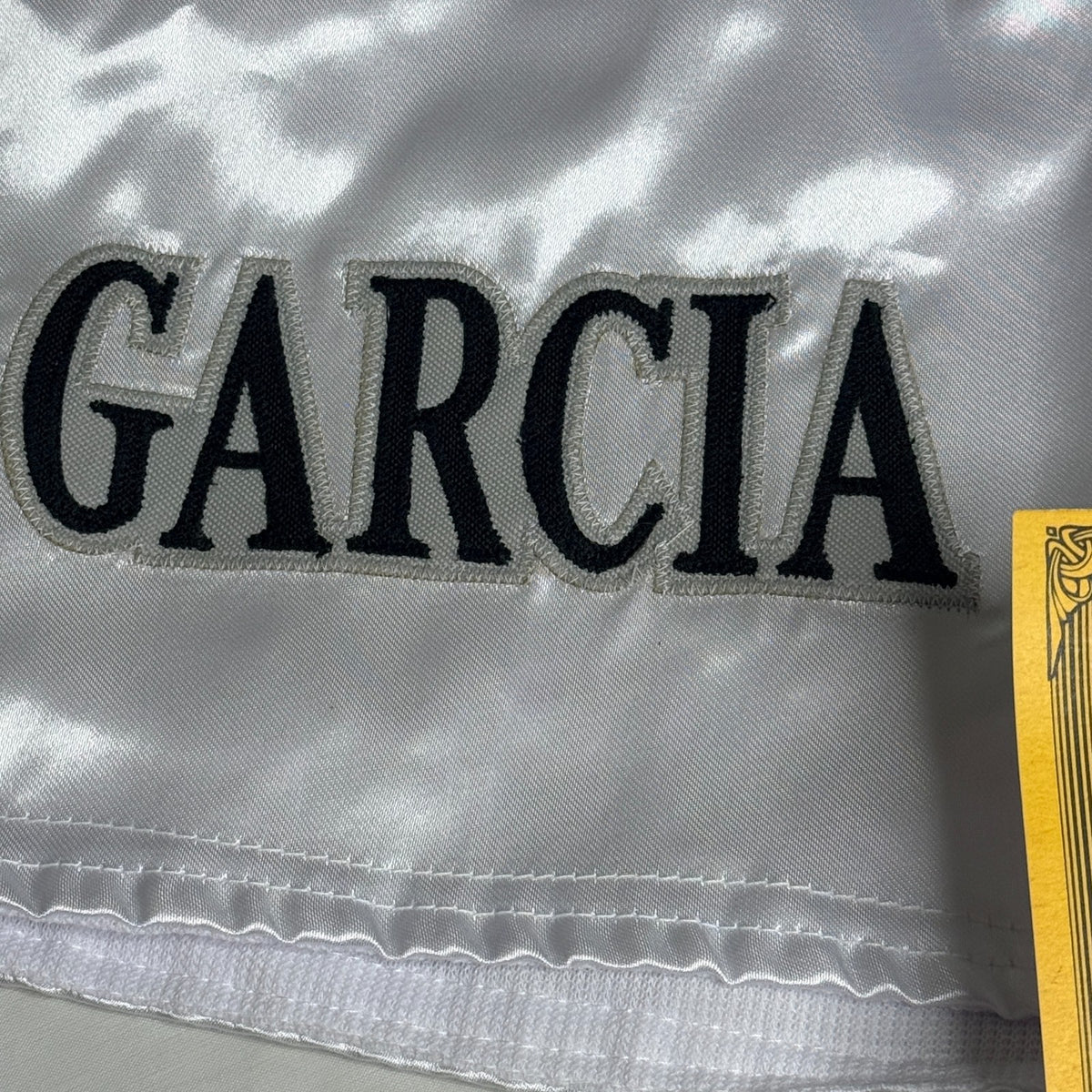 Black and silver boxing shorts signed by Ryan Garcia, featuring the word 'king' and a Certificate of Authenticity.