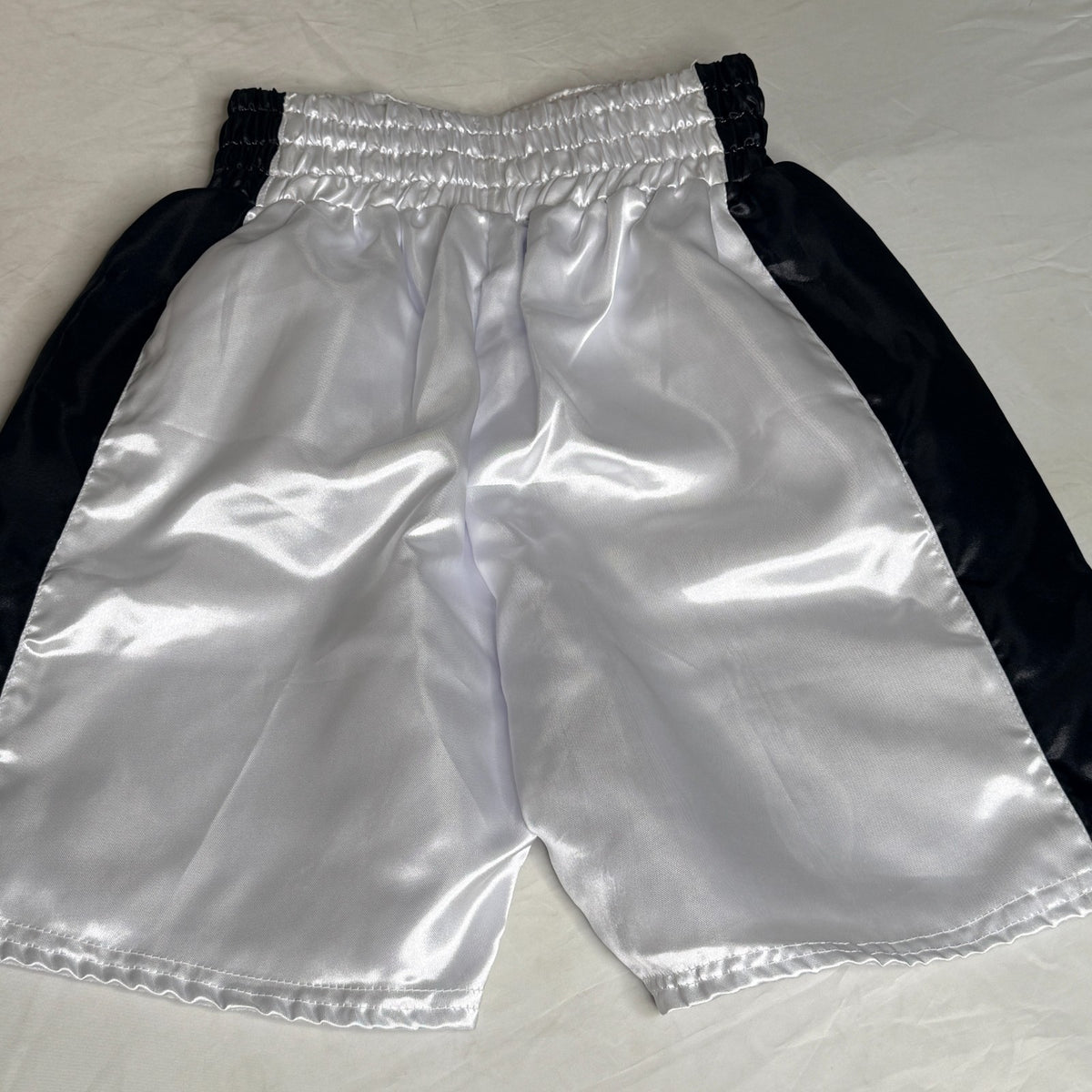 Black and silver boxing shorts signed by Ryan Garcia, featuring the word 'king' and a Certificate of Authenticity.