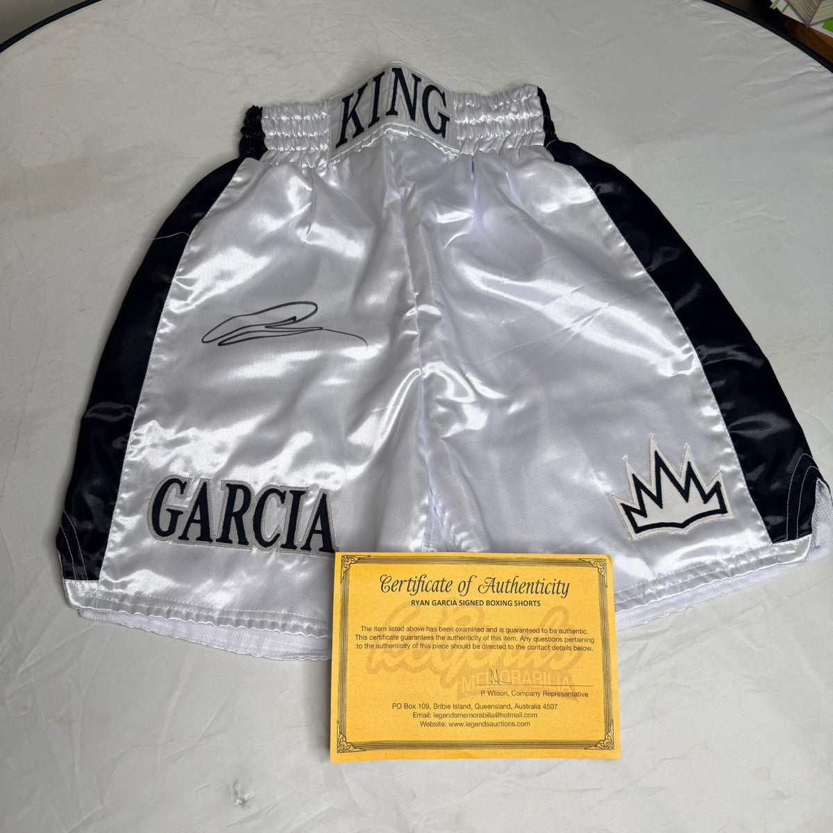 Black and silver boxing shorts signed by Ryan Garcia, featuring the word 'king' and a Certificate of Authenticity.