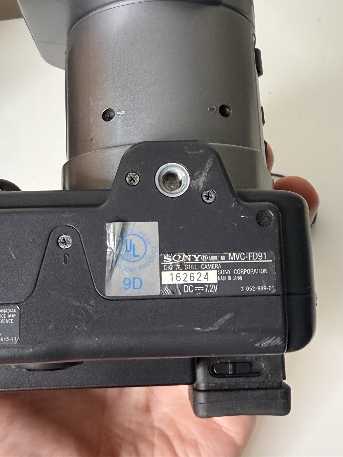 Vintage Sony Digital Mavica MVC-FD91 camera in black and grey, featuring 3.5-inch floppy disk storage.
