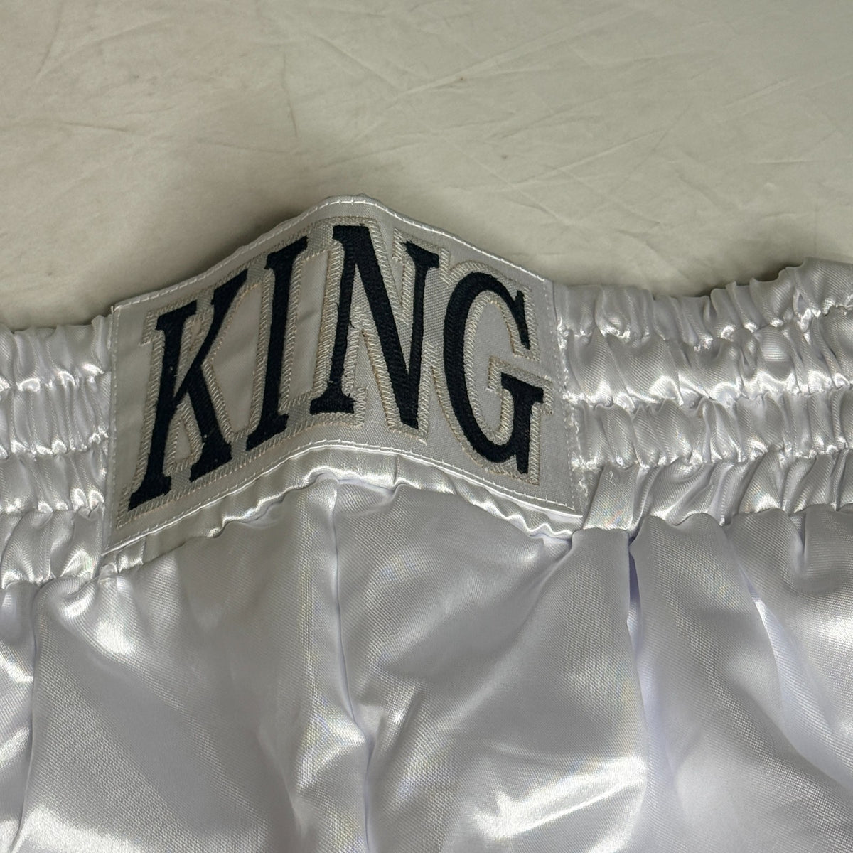 Black and silver boxing shorts signed by Ryan Garcia, featuring the word 'king' and a Certificate of Authenticity.