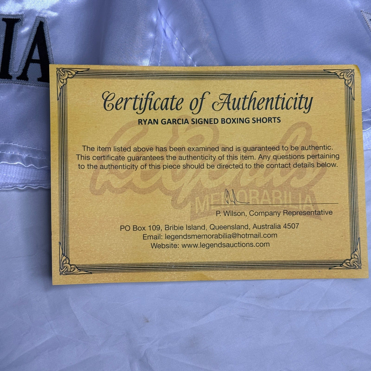 Black and silver boxing shorts signed by Ryan Garcia, featuring the word 'king' and a Certificate of Authenticity.