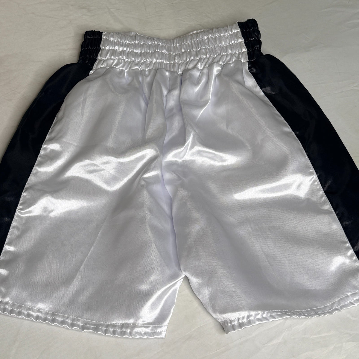 Black and silver boxing shorts signed by Ryan Garcia, featuring the word 'king' and a Certificate of Authenticity.