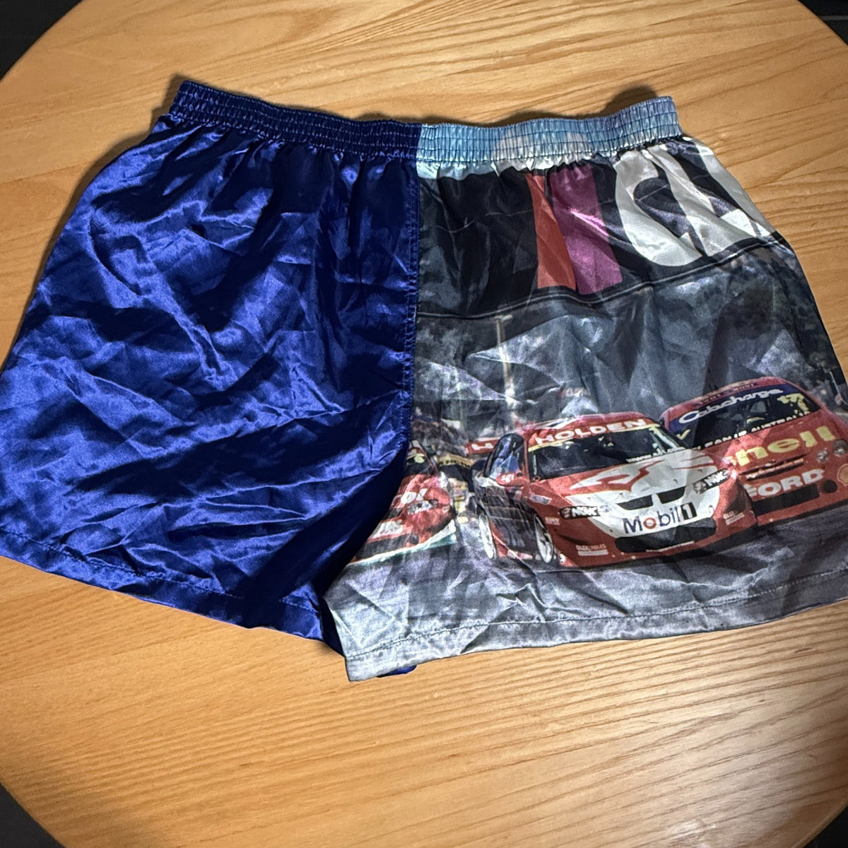 Blue satin boxer shorts featuring Clipsal 500 V8 Supercars print, size M (85–90cm), elasticated waist.